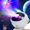 A white astronaut projector with a purple lens emitting colorful nebula and galaxy light onto a dark background.
