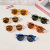 A collection of colorful sunglasses in various styles and colors including yellow, green, brown, and blue.