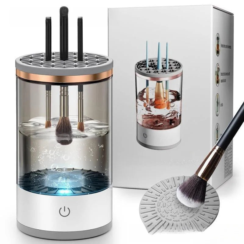 A white electric makeup brush cleaner device and brush are shown next to its packaging box.