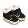 Pair of black baby winter snow boots with fluffy cream faux fur trim.