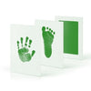 A set of white frames displaying green handprint and footprint imprints.