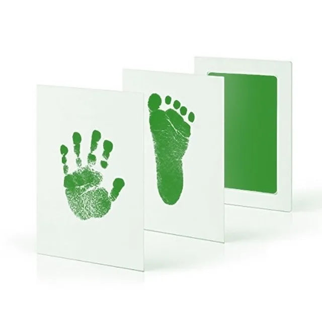 A set of white frames displaying green handprint and footprint imprints.