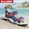 A pair of blue and white breathable summer sport sandals resting on light-colored sand near the sea.