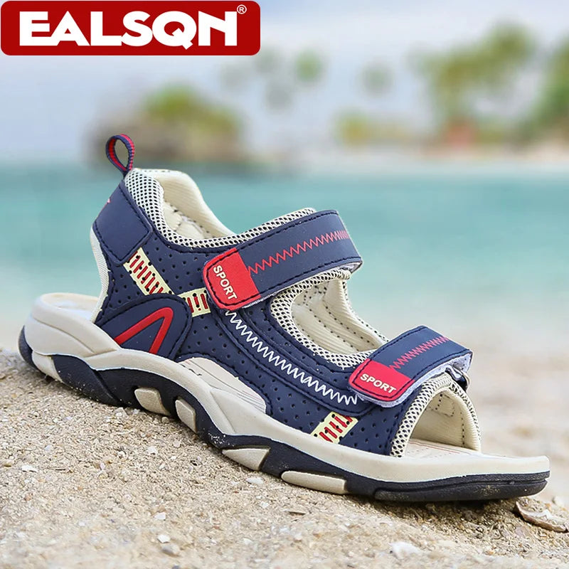 A pair of blue and white breathable summer sport sandals resting on light-colored sand near the sea.