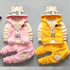 A set of three pink and yellow cartoon fleece pajama loungewear for a child.