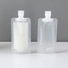 Two clear plastic bottles with white liquid and white caps for portable travel refills