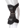 A black spring-assisted knee support brace worn on a person's leg.