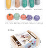 A wooden pretend play food cutting set for kids showing various shaped food items and tools.