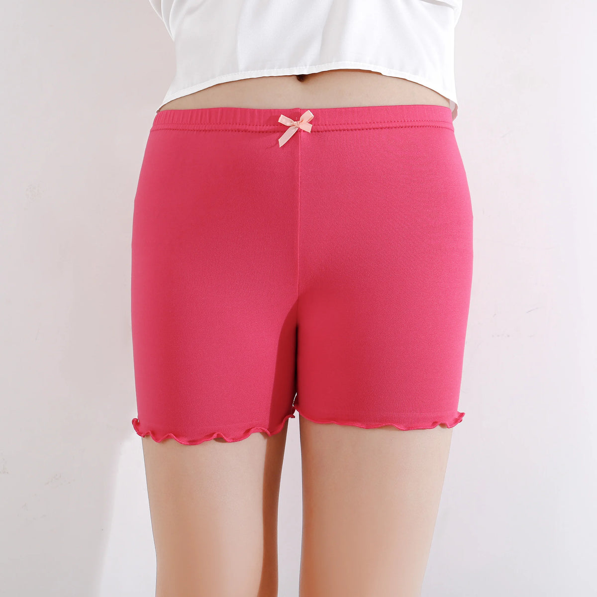A pair of bright pink girls bow safety shorts with a pink ribbon detail