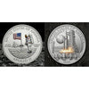 A commemorative space coin featuring an astronaut, the United States flag, and a rocket against a lunar background.