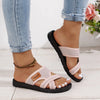 A pair of pink breathable mesh flat sandals with black soles worn on a person's foot.