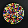 A circular display of 300 colorful water beads in various shades of pink, blue, green, yellow, and orange.