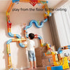 A colorful magnetic train building blocks set with a gravity maze installed on a wall for children to play from the floor to 