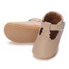 A pair of beige soft non-slip baby first walker shoes shown from the side.