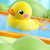 A yellow duck bath toy is shown splashing water in a blue tub, surrounded by green and orange plastic elements.