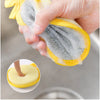 A hand is holding a yellow double-sided non-stick dish sponge with a scouring pad, demonstrating its multi scenario usage.
