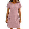 A woman wearing a dusty rose lightweight cotton-linen short sleeve dress with a zipper and front pockets.