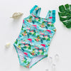 A turquoise one-piece swimsuit featuring a vibrant pattern of pink and green tropical flowers and birds.
