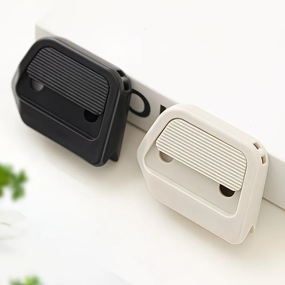 A black and white retractable ceramic blade cutter with a magnetic lock shown on a white surface.