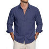 A dark blue men's classic cotton long sleeve button-down shirt worn by a man.