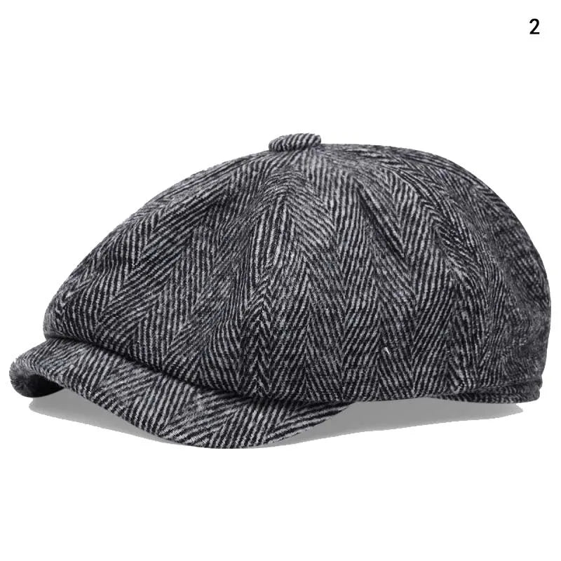 A dark gray vintage newsboy cap with a textured herringbone pattern shown in profile.
