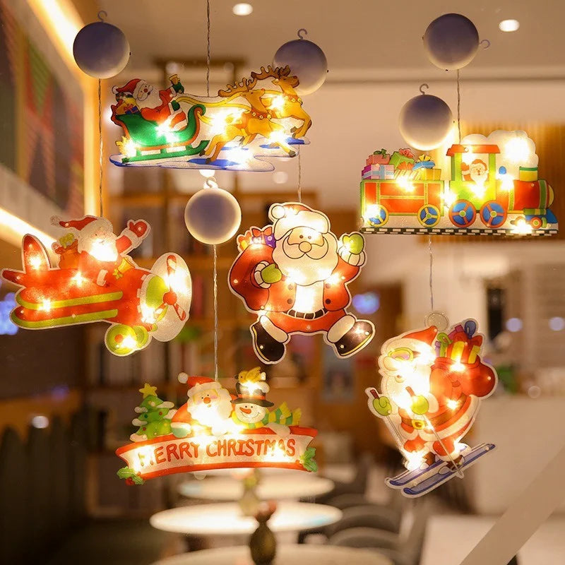 A collection of festive LED Santa Claus window decorations and lights hanging from a ceiling.