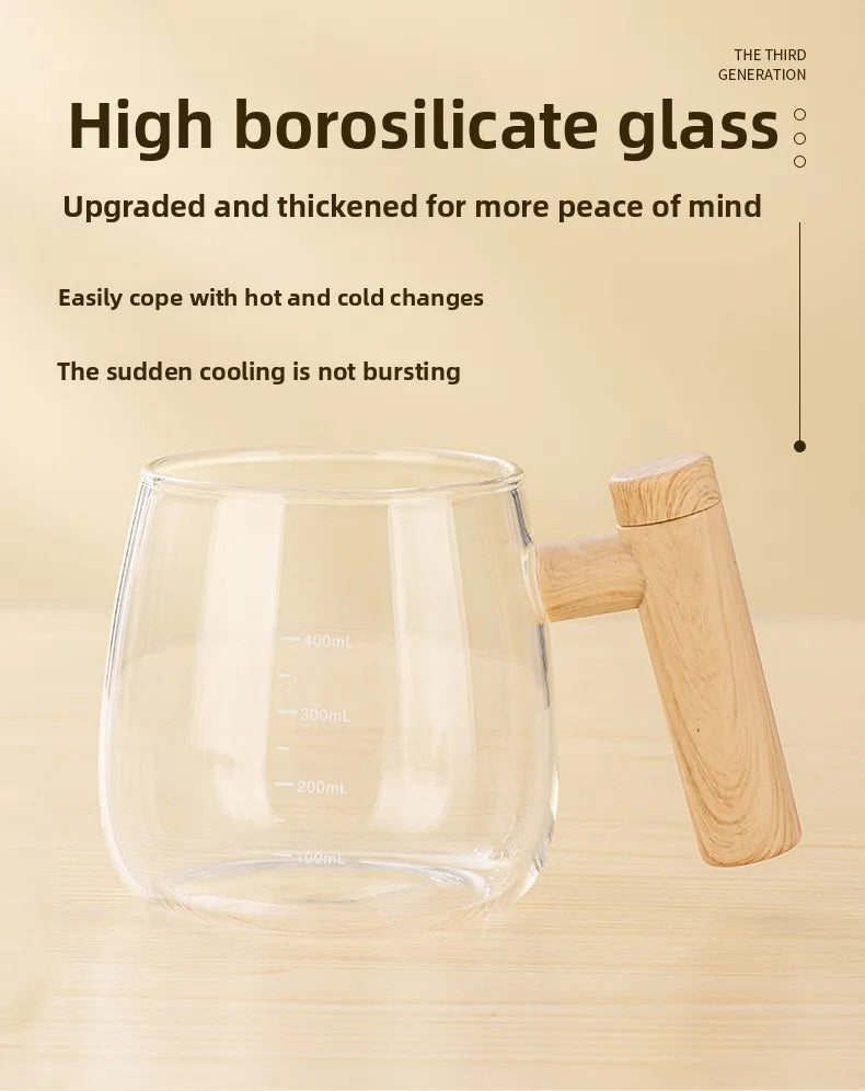 A clear borosilicate glass mug with a wooden handle is shown on a light wooden surface.