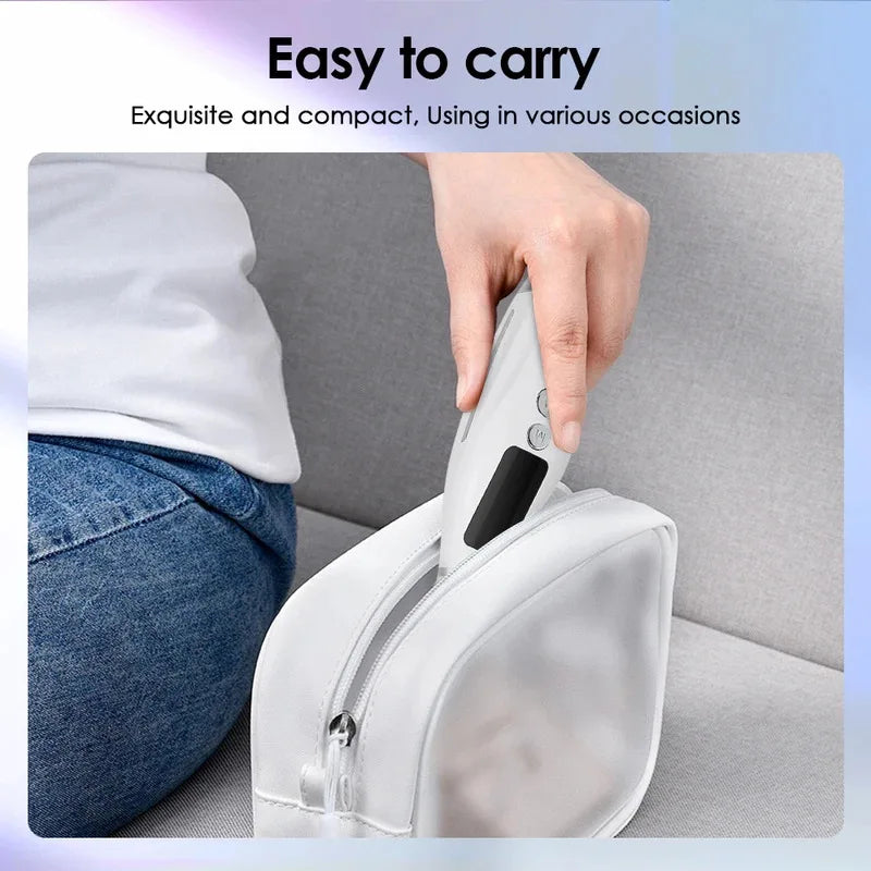 A hand is carrying a white LED light therapy neck and face massager with vibration in a zippered pouch.