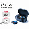 Black wireless earbuds in an open charging case with an LED power display and user manual nearby