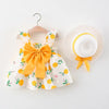 A baby girls summer floral dress and sunhat set featuring yellow and white patterns.