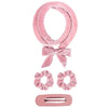Pink satin heatless overnight curling headband tied in a bow with a rectangular clip.