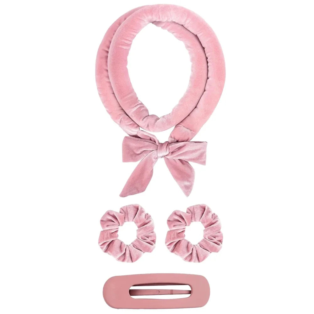 Pink satin heatless overnight curling headband tied in a bow with a rectangular clip.