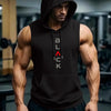 A muscular man wearing a black performance hooded tank top stands in a gym setting.