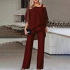 En kvinne modellerer et rødbrunt to-delt sett med off-shoulder topp og brede bukser.