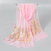 Pink gold shimmer chiffon scarf and head wrap displayed on a hanger.