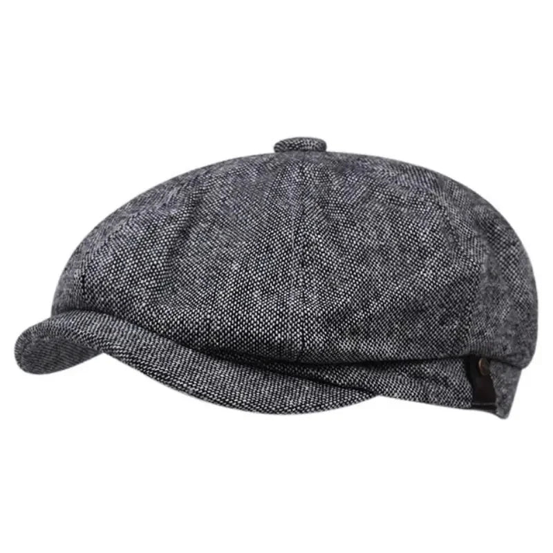 A dark gray vintage newsboy cap with a folded brim and tweed texture.