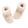 A pair of beige faux fur baby winter snow boots for toddlers.