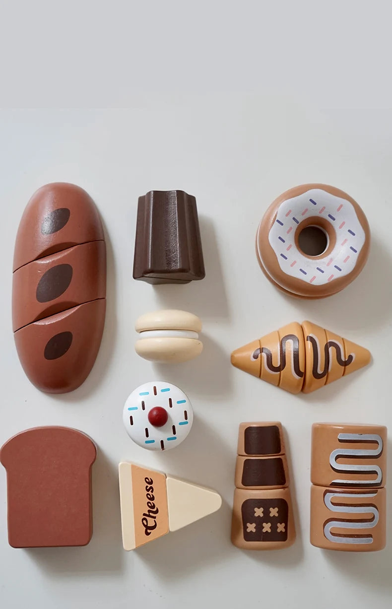 A collection of wooden pretend play food items including a donut, bread, and cheese slices.