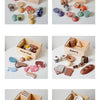 A wooden pretend play food cutting set with various shapes and colors of food items.