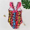 A vibrant kids mermaid unicorn one-piece swimsuit featuring a leopard print with pink, blue, and yellow colors.