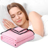 A woman is relaxing with a pink breathable cooling throw blanket on her arm while resting in bed.