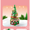 A green Christmas tree building block set with a snow house, Santa, and deer figures.