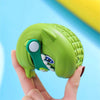 A hand holds a green kids shark clog sandal with an anti-slip sole against a light blue background.