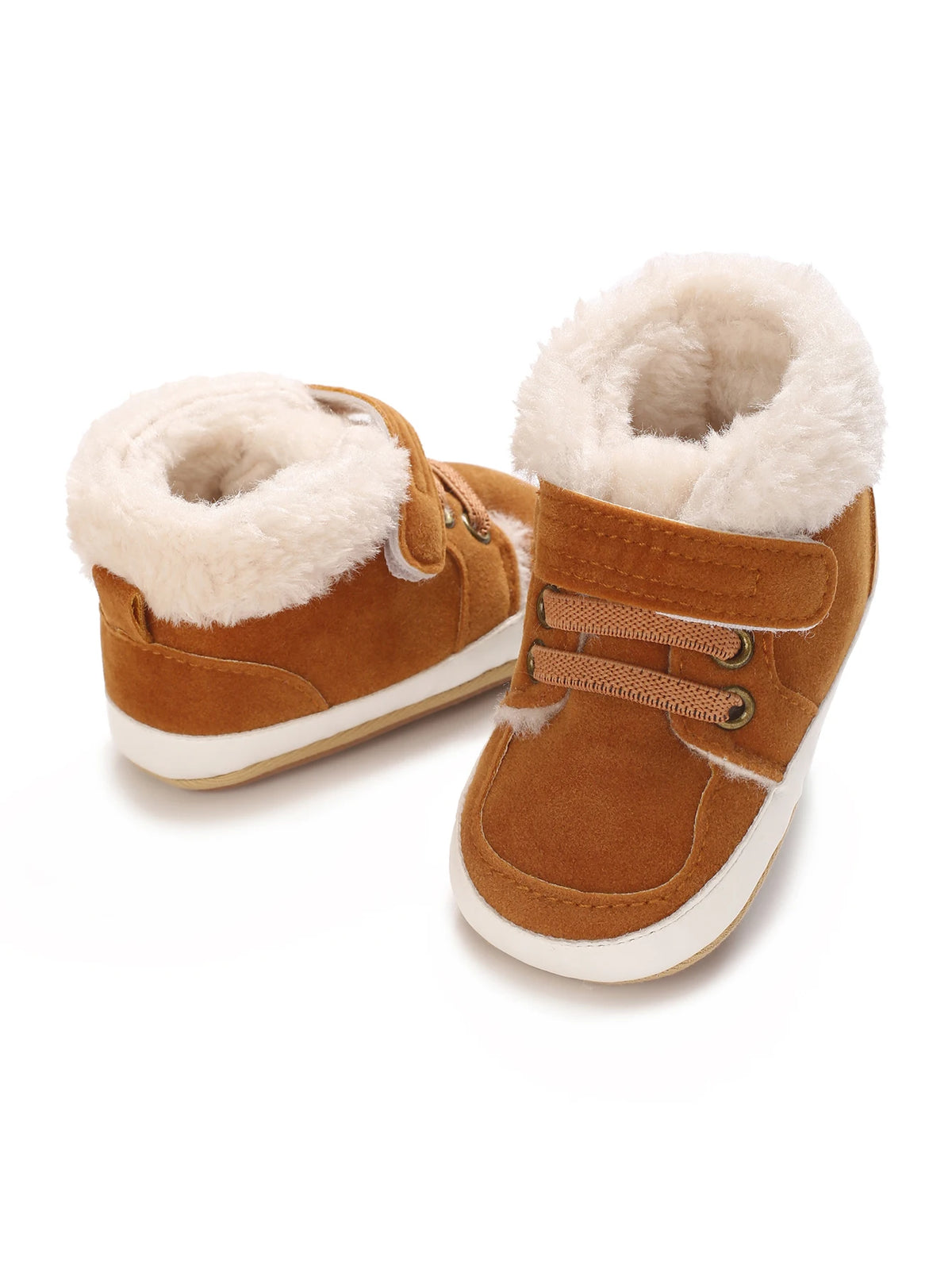 A pair of tan suede baby winter snow boots with fluffy cream-colored faux fur lining and white soles.