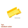 A yellow plastic marble run building block piece with tracks and funnels, measuring 8x4.3x3cm.