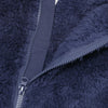 Close-up of a dark blue fuzzy fleece garment with a visible zipper detail.