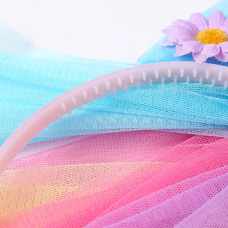 Pink and blue mesh fabric with a pink headband and a purple flower accessory