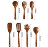 A set of natural teak wood cooking utensils including spoons and spatulas.