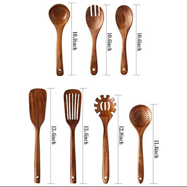 A set of natural teak wood cooking utensils including spoons and spatulas.