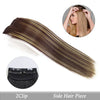 A side hair piece featuring long, straight brown hair with blonde highlights, shown alongside a clip-in hair pad.